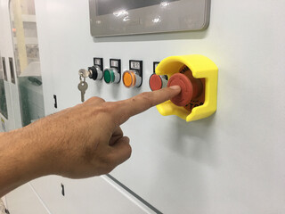 hand touch on Emergency button machine in factory industrial