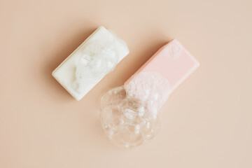 Natural organic handmade soap with large bubbles of foam on pastel background. Health beauty natural products concept. 
