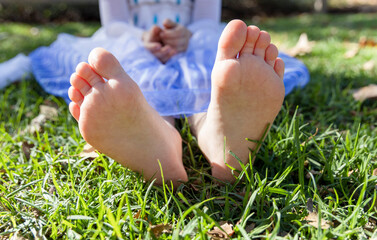 little girl's wide feet in grass