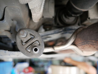 car exhaust pipe rubber hanger at garage.	
