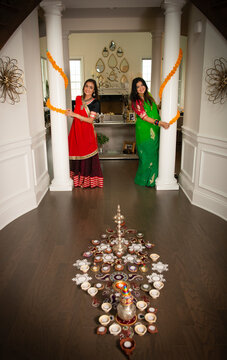 Women decorating home for Diwali 
