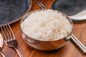 Korean steamed rice in silver cup ready to eat, Korean style