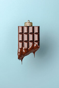 Christmas bauble decoration of chocolate on blue. New year concept.