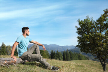 Man enjoying beautiful mountain landscape on sunny day