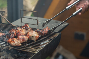 A barbecue grill with tasty juicy steaks are grilled over an open fire.