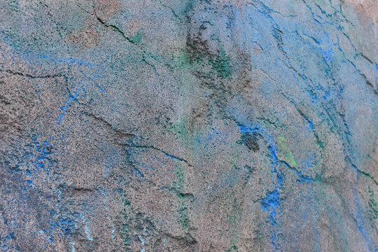 Colored streaks on a granite stone. Texture, surface, background