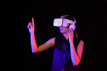 Metaverse Concepts, Asian woman in vr glasses, playing video games with virtual reality headset and pointing something 