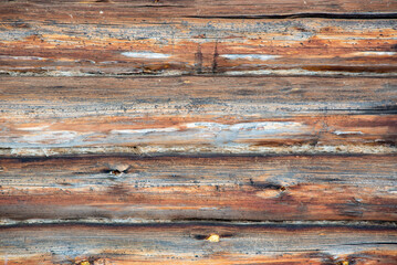 Old logs. A log house made of darkened wood.