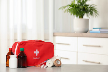 First aid kit on table indoors, space for text