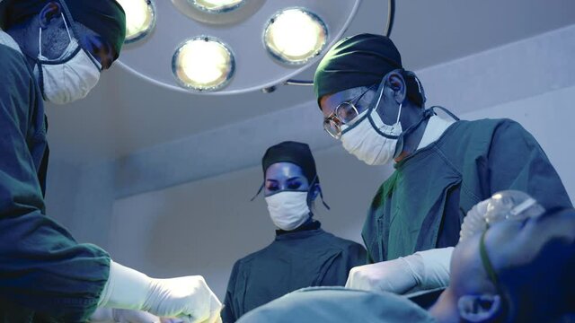 Medical surgical doctor team performing surgery patient, Group surgeon at work on operating room with electrocautery equipment for cardiovascular emergency surgery center in hospital