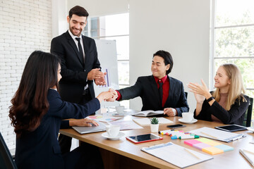 Faceless man shaking hand of positive colleague