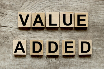 Value Added. text on wood blocks on wood table