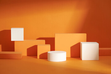 Front view of white and orange podium in a orange background for advertising , abstract content