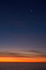 Moon over sea at dusk