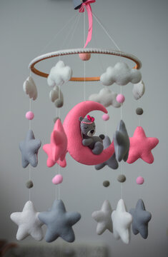 Baby cot mobile, musical toy hanging over the baby crib. Dreamy bear in the moon, space-themed felt cot mobile.