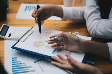 Multiracial business people gather to discuss the company's market plan for the coming year. Teamwork Togetherness Unity Concept.