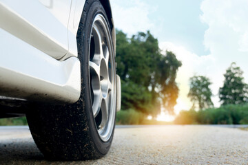 Close-up skirt of Beside white car. View of the front suspension vehicle that sees the wheels and...