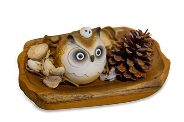 Owl doll wood with pine cones focus selective