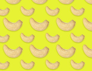 Many tasty cashew nuts on yellow background, flat lay