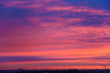 the sky is blue with red clouds at dawn