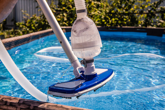 cleaning the pool with a vacuum cleaner. Cleaning equipment for small pools