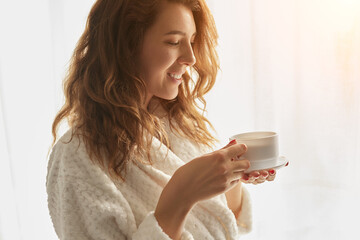 Woman with coffee in morning at home