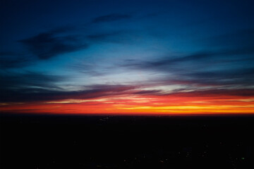 Beautiful dramatic sky with clouds at sunset. Natural sunrise over city.