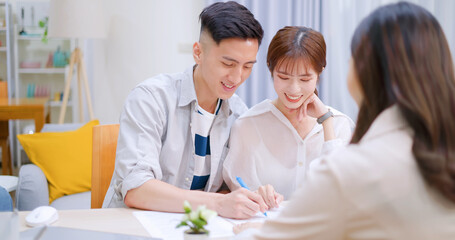asian couple signing a contract