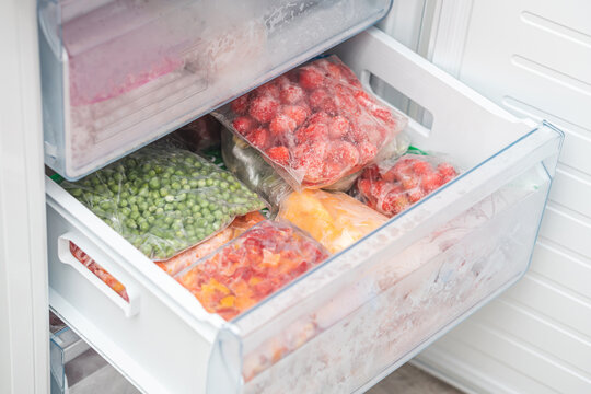 Bags with frozen vegetables in refrigerator. frozen fruits and vegetables.