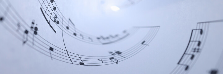 White paper with musical notes rolled up closeup background