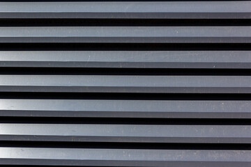 Obraz premium Corrugated sheet metal, badly painted with gray paint for background. Metal corrugated roofing sheet.Painting of metal surfaces for rust control Abstract background for sites and layouts. Iron fence