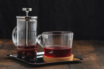 Hot winter tea served with a french press on a wooden floor