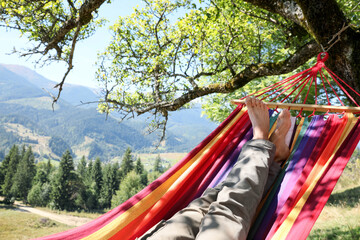 Man resting in hammock outdoors on sunny day, closeup