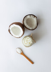 Coconut oil in a jar and fresh coconuts. Natural cosmetics.