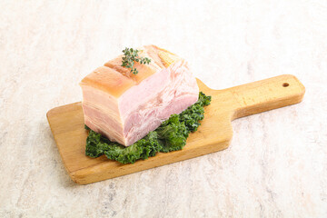 Cut of pork bacon over board