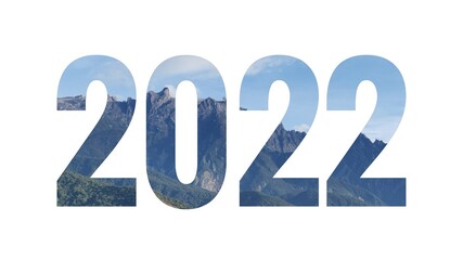 New year concept. White paper cut out number 2022 layer against nature background.
