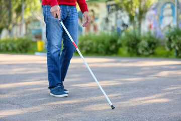 Blind senior man walking outdoors