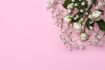 Beautiful white gypsophila and roses on pink background, top view. Space for text