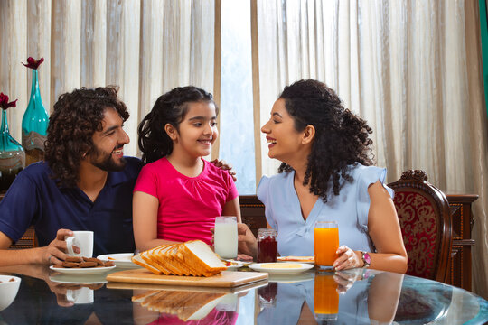 Family sharing an intimate moment at the breakfast table in the moring at home