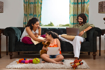 Family members spending their leisure time with various gadgets at home