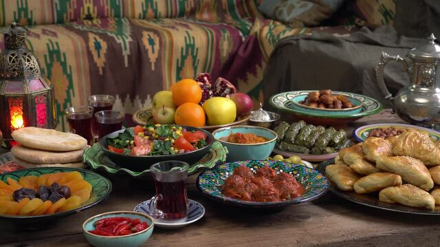 Holiday islamic table with dates, Oriental food and sweets. Eid mubarak. Traditional Middle Eastern cuisine, evening meal. Ramadan iftars marks the end of fasting