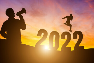 Happy New Year Numbers 2022, Silhouette a man handsome wearing shouting with megaphone and man jumping feels happy moving morning over the horizon background, Health and Happy new year concept.