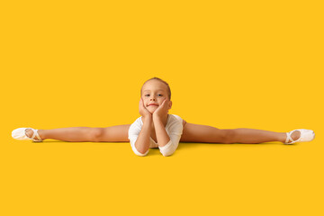 Little girl doing gymnastics on color background