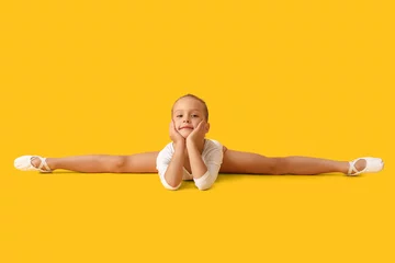 Foto op Plexiglas Little girl doing gymnastics on color background © Pixel-Shot