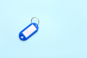 Plastic key tag on blue background