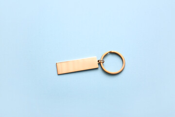 Stylish key chain on blue background