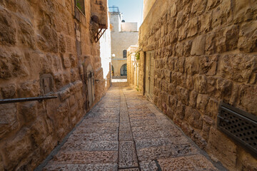 An old and ancient alley paved with stone tiles, in the Jewish Quarter - in the Old City of Jerusalem - Israel