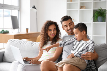 Interracial family video chatting at home - Powered by Adobe