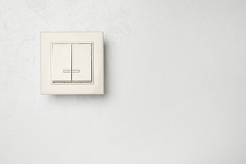 Modern light switch on white background. Space for text