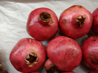 Pomegranate garnet fruit. Whole pomegranate. Fresh raw organic garnet fruit pile texture background. Heap of natural ruby pomegranate (garnet fruit) close-up top view. 